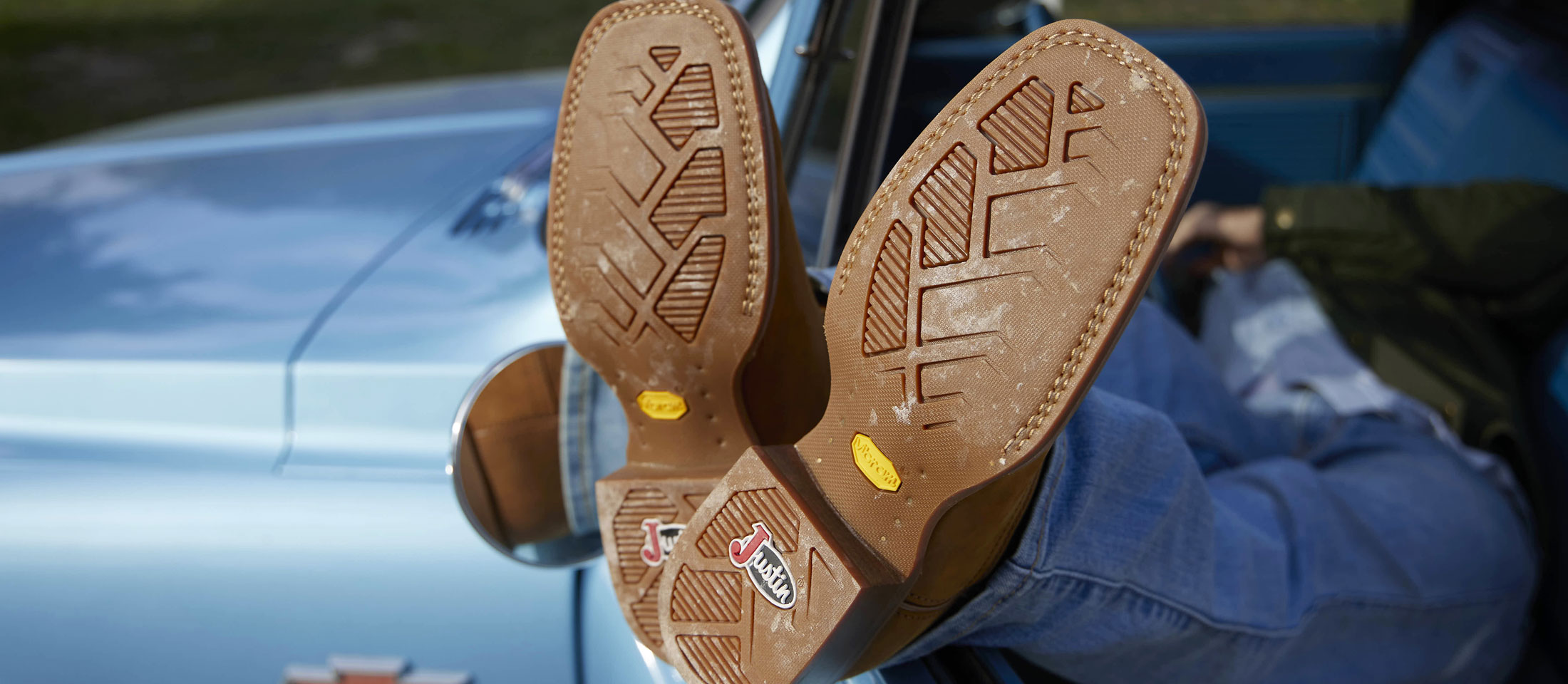A close-up of the outsoles on a pair of Justin cowboy Boots.